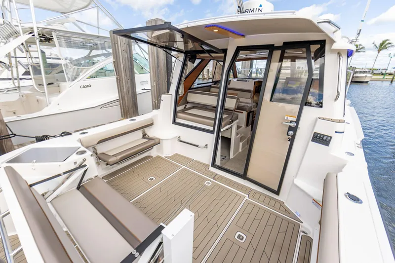 Slide: The Image of 2026 Cutwater C-288 C boat interior with open seating and modern design at a marina. - 4