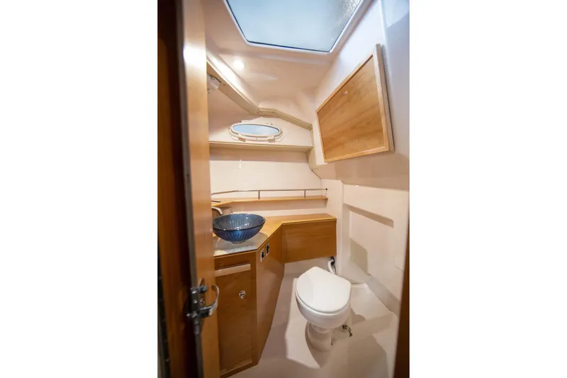 Slide: The Image of 2026 Cutwater C-288 C boat bathroom with wooden cabinetry and modern fixtures. - 5