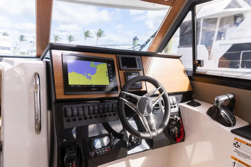 Slide: The Image of 2026 Cutwater C-288 C helm with navigation display and steering wheel. - 8