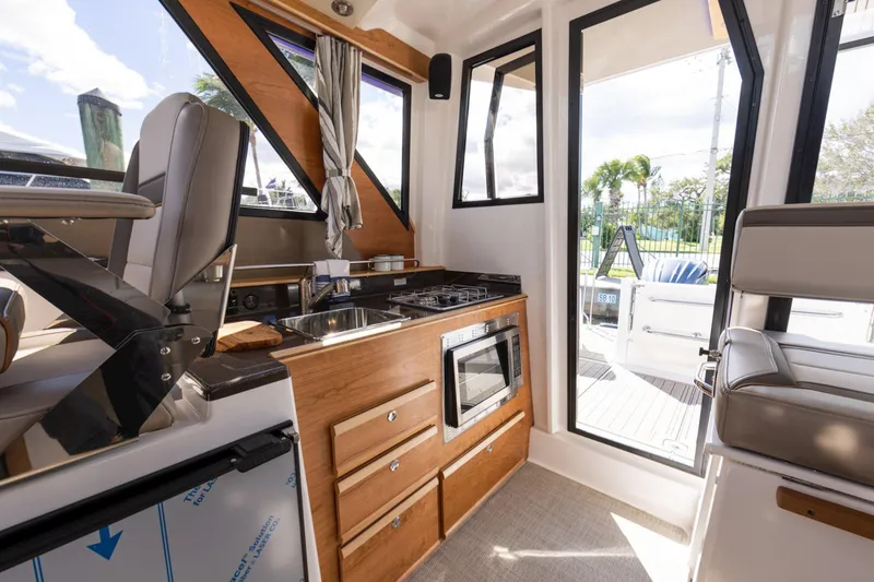 Slide: The Image of Interior of 2026 Cutwater C-288 C boat with modern kitchen and seating area. - 9