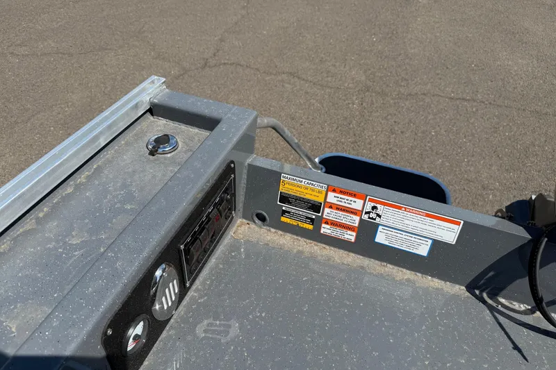 Slide: The Image of Control panel of 2026 Fish Rite Angler 18 boat with warning labels and capacity information. - 14