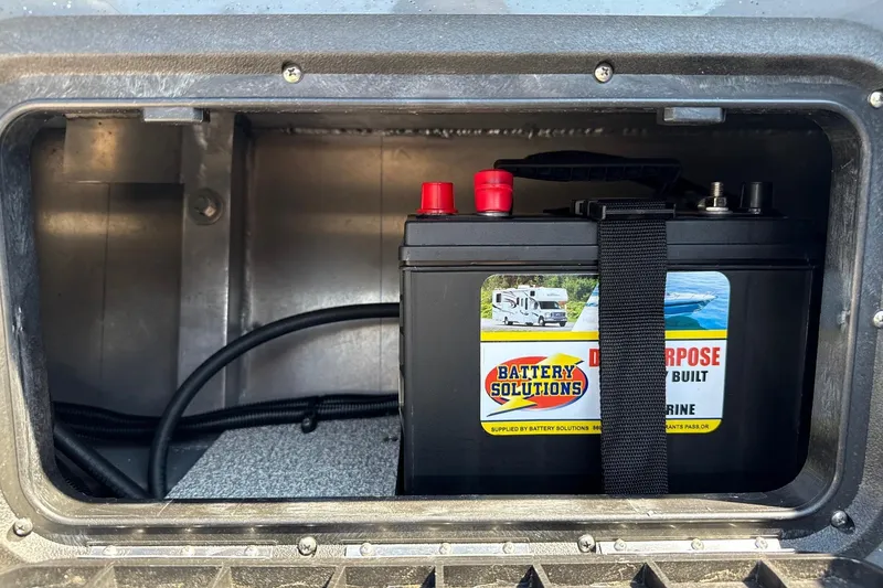 Slide: The Image of Battery compartment of 2026 Fish Rite Angler 18 boat with secured marine battery. - 17