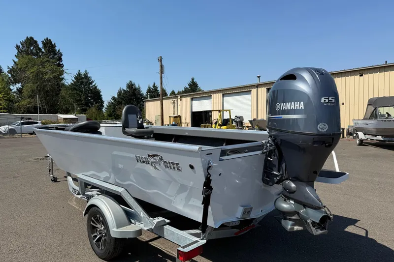 Slide: The Image of 2026 Fish Rite Angler 18 boat with Yamaha 65 Jet Drive engine on trailer. - 2