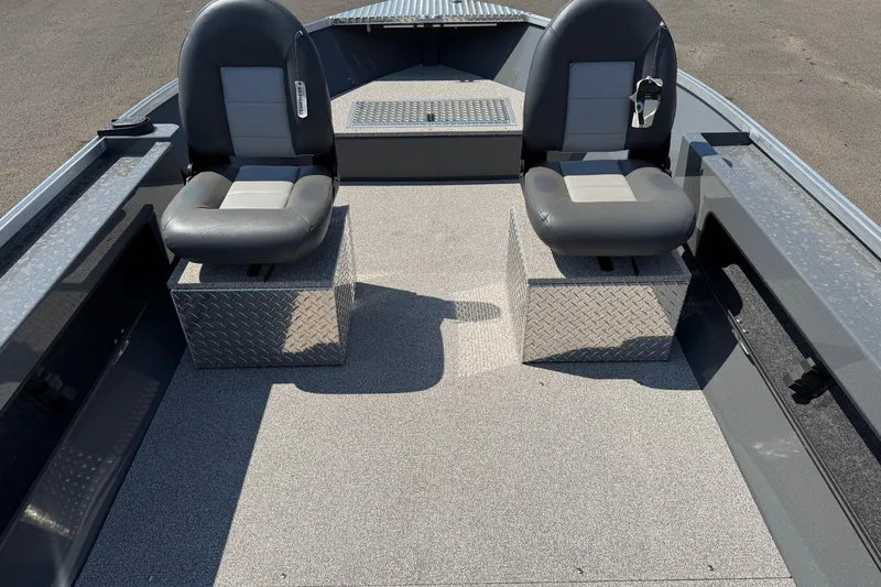 Slide: The Image of 2026 Fish Rite Angler 18 boat interior with two cushioned seats and diamond plate flooring. - 8
