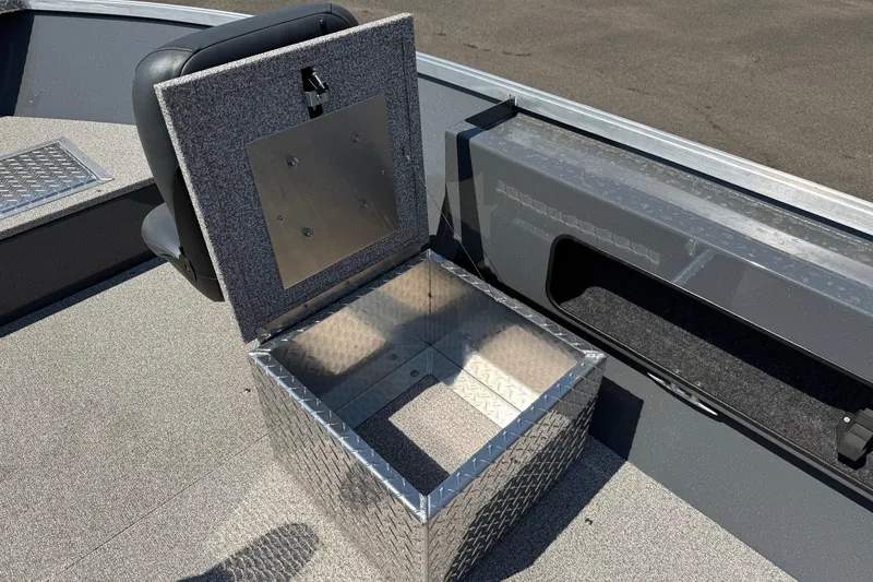 Slide: The Image of Open storage compartment on 2026 Fish Rite Angler 18 boat, featuring diamond plate design. - 9