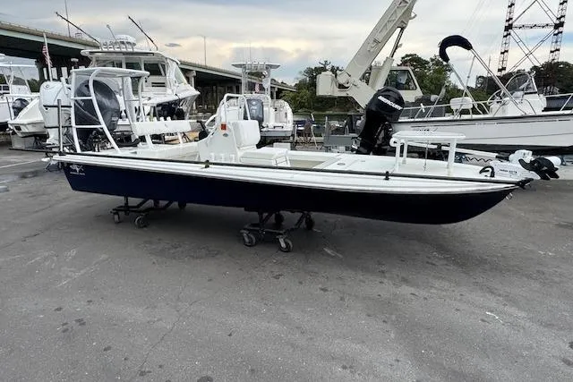 Slide: The Image of 2024 Beavertail Skiffs Vengeance boat on display at a marina. - 0
