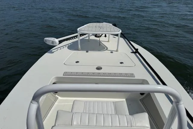 Slide: The Image of 2024 Beavertail Skiffs Vengeance on water, showcasing sleek design and spacious deck. - 1
