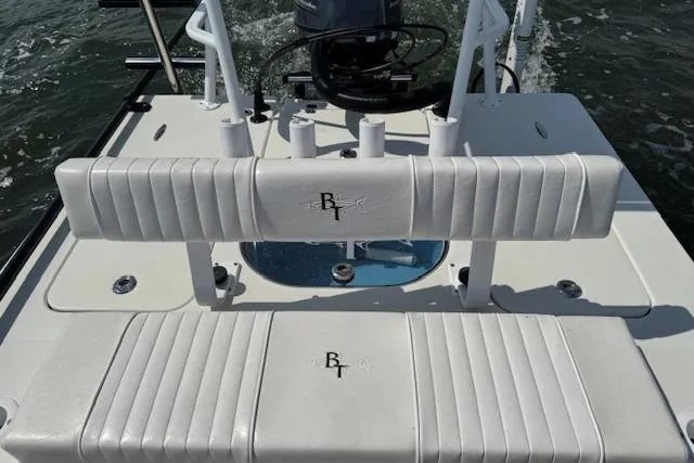 Slide: The Image of 2024 Beavertail Skiffs Vengeance boat interior with cushioned seating and rod holders. - 12