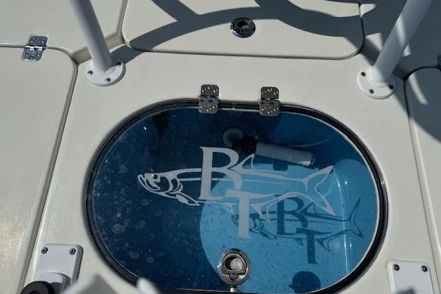 Slide: The Image of 2024 Beavertail Skiffs Vengeance livewell with logo and fish graphic. - 13