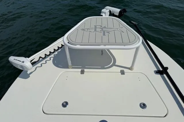 Slide: The Image of 2024 Beavertail Skiffs Vengeance boat deck with trolling motor on calm water. - 16