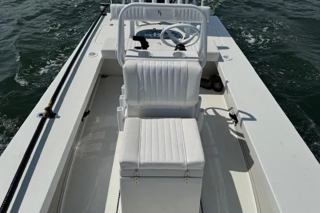 Slide: The Image of 2024 Beavertail Skiffs Vengeance boat interior with white seating on open water. - 19