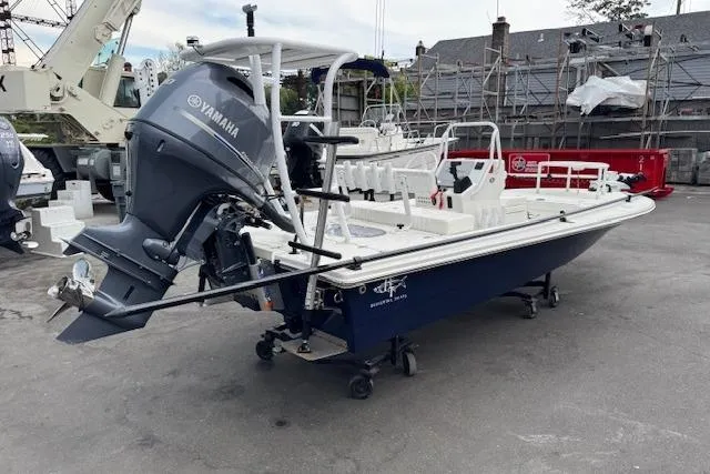 Slide: The Image of 2024 Beavertail Skiffs Vengeance boat with Yamaha engine, parked in a marina setting. - 25