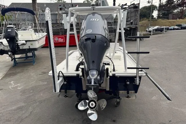 Slide: The Image of 2024 Beavertail Skiffs Vengeance boat with 90 HP engine, rear view in marina setting. - 26