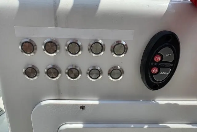 Slide: The Image of Control panel of 2024 Beavertail Skiffs Vengeance with buttons and switches. - 5