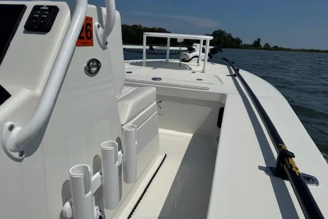 Slide: The Image of 2024 Beavertail Skiffs Vengeance on water, showcasing sleek design and fishing rod holders. - 7