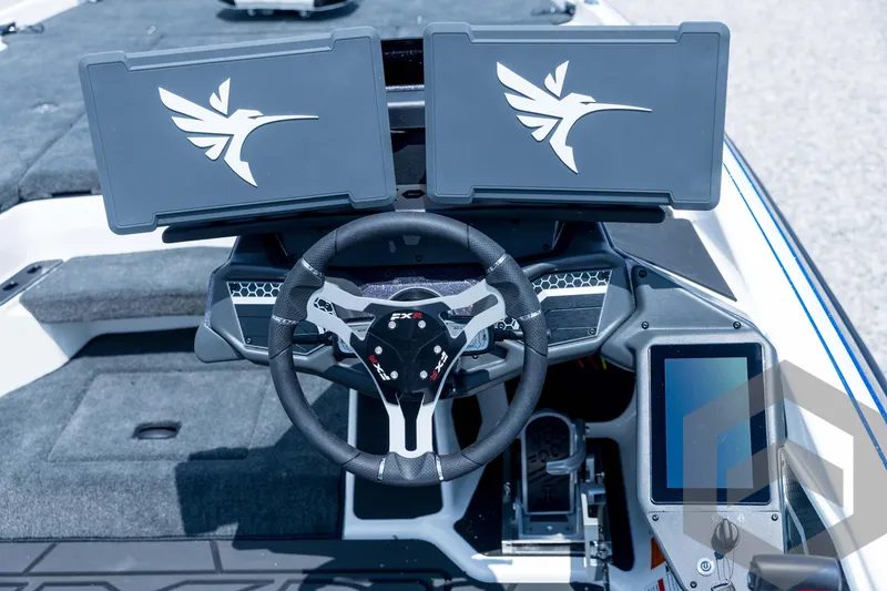 Slide: The Image of 2026 Skeeter FXR21 FLEX boat dashboard with dual screens and steering wheel. - 15