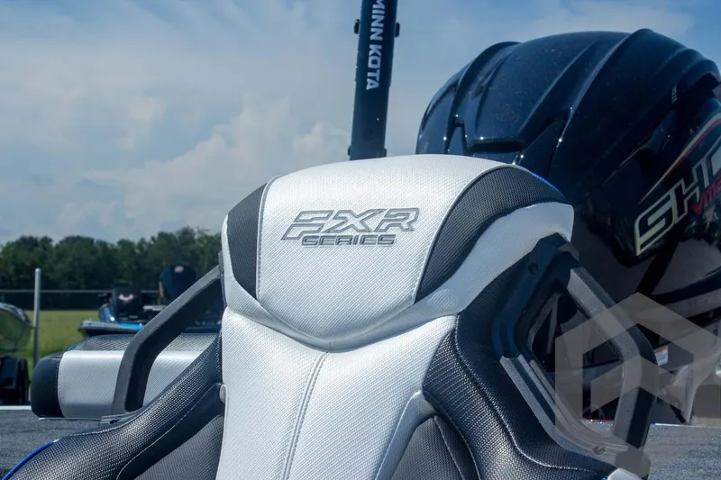 Slide: The Image of 2026 Skeeter FXR21 FLEX boat seat with logo, outdoors under blue sky. - 21