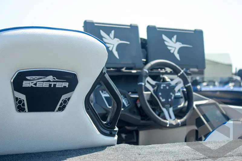 Slide: The Image of 2026 Skeeter FXR21 FLEX boat interior with steering wheel and branded seat. - 22