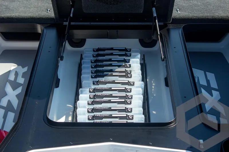 Slide: The Image of 2026 Skeeter FXR21 FLEX boat storage compartment with organized tackle boxes. - 30