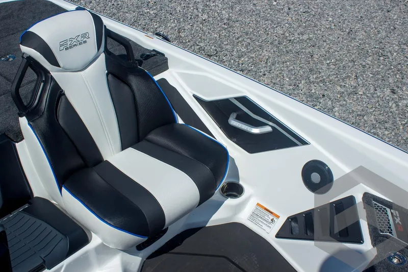 Slide: The Image of 2026 Skeeter FXR21 FLEX boat interior with black and white seating and control panel. - 36
