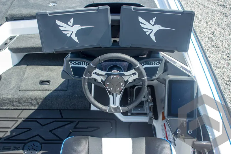 Slide: The Image of 2026 Skeeter FXR21 FLEX boat cockpit with dual screens and steering wheel. - 37