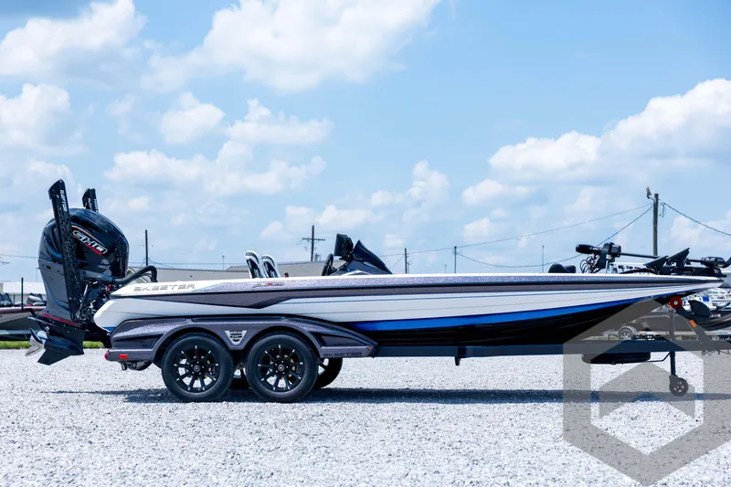 Slide: The Image of 2026 Skeeter FXR21 FLEX boat on trailer, under clear blue sky. - 4