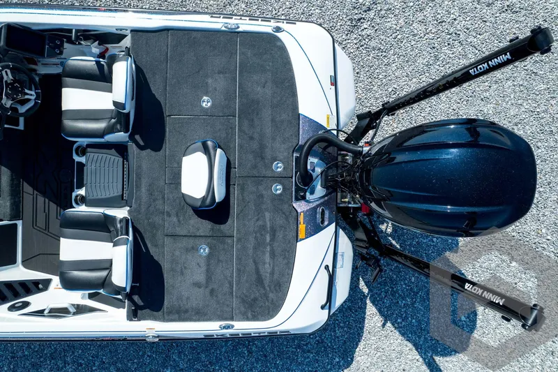 Slide: The Image of Top view of 2026 Skeeter FXR21 FLEX boat interior and motor on gravel. - 48