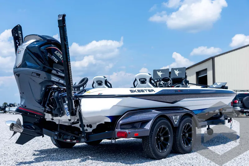Slide: The Image of 2026 Skeeter FXR21 FLEX boat with Yamaha engine on a trailer, parked outdoors. - 5