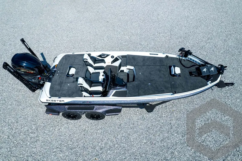 Slide: The Image of 2026 Skeeter FXR21 FLEX boat on gravel, featuring dual seats and Yamaha engine. - 51