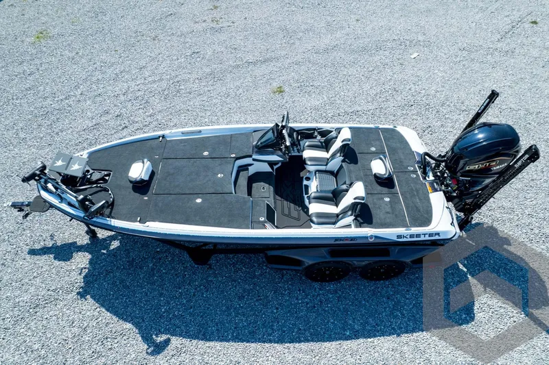 Slide: The Image of 2026 Skeeter FXR21 FLEX boat on gravel, featuring sleek design and modern seating. - 55