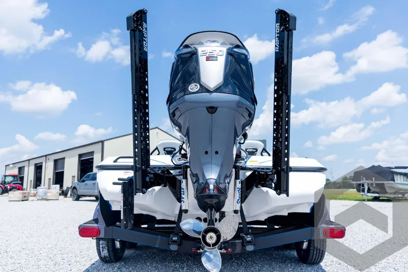 Slide: The Image of 2026 Skeeter FXR21 FLEX boat with powerful engine, parked outdoors on gravel. - 6