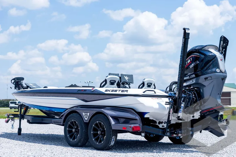 Slide: The Image of 2026 Skeeter FXR21 FLEX boat on trailer, featuring Yamaha engine, under a clear blue sky. - 7