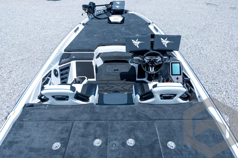 Slide: The Image of 2026 Skeeter FXR21 FLEX boat interior with dual screens and modern steering console. - 9