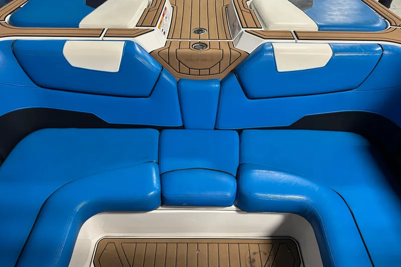 Slide: The Image of 2018 Nautique Super Air Nautique GS24 interior with blue and white seating. - 12