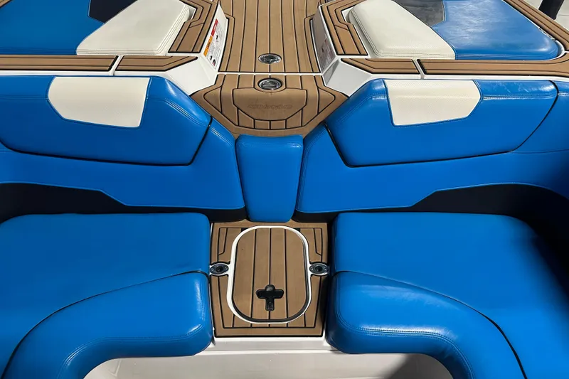 Slide: The Image of 2018 Nautique Super Air Nautique GS24 interior with blue and white seating. - 13