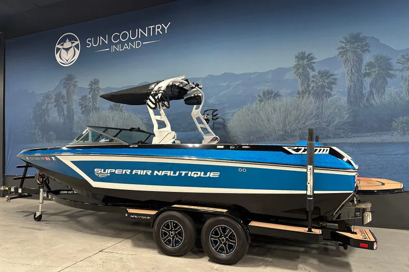 Slide: The Image of 2018 Nautique Super Air Nautique GS24 boat displayed indoors at Sun Country Inland. - 2