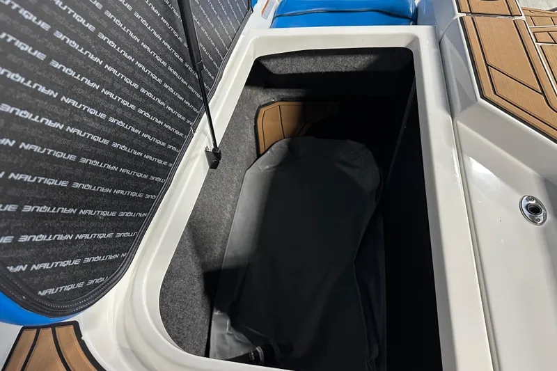 Slide: The Image of 2018 Nautique Super Air Nautique GS24 storage compartment with branded interior lining. - 21