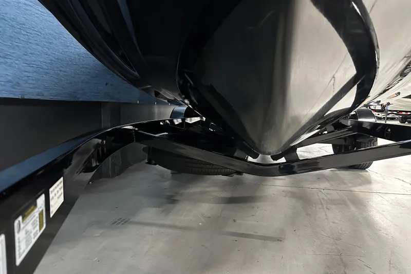 Slide: The Image of 2018 Nautique Super Air Nautique GS24 boat hull on trailer, close-up view. - 3