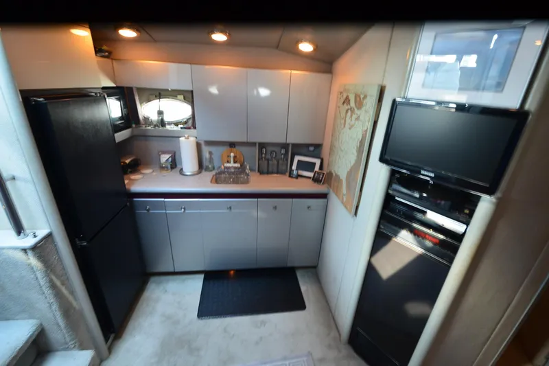 Slide: The Image of Compact kitchen in a 1991 Baron 43-E yacht with modern appliances and sleek cabinetry. - 16