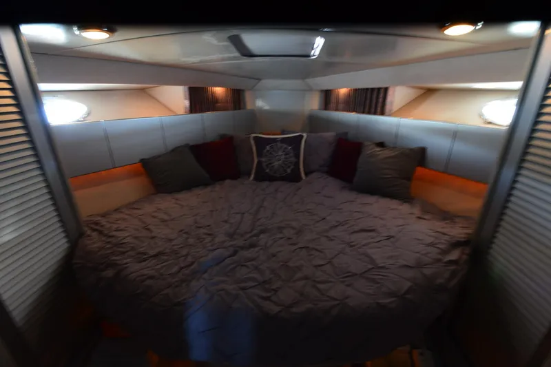 Slide: The Image of Cozy cabin interior of 1991 Baron 43-E yacht with plush bedding and ambient lighting. - 22
