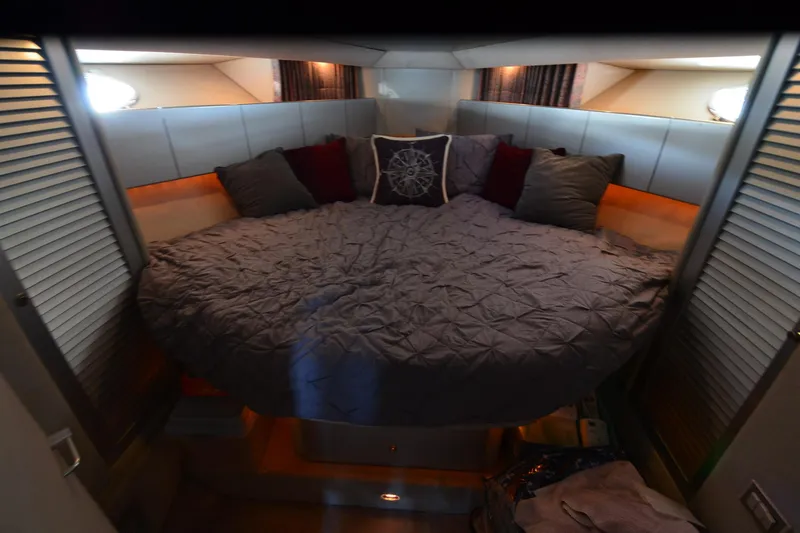 Slide: The Image of Cozy bedroom interior of 1991 Baron 43-E yacht with plush bedding and ambient lighting. - 23