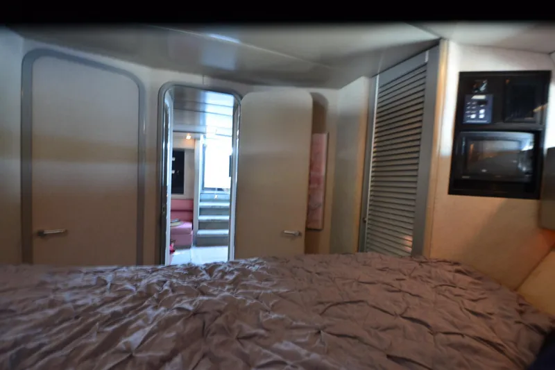 Slide: The Image of Interior of 1991 Baron 43-E yacht with bed, doors, and microwave. - 24