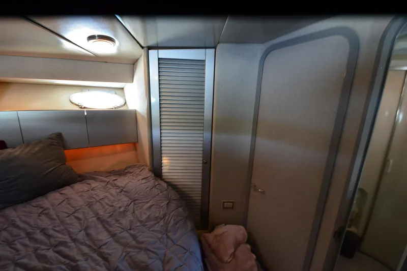 Slide: The Image of Cozy bedroom interior of 1991 Baron 43-E yacht with modern lighting and storage. - 25