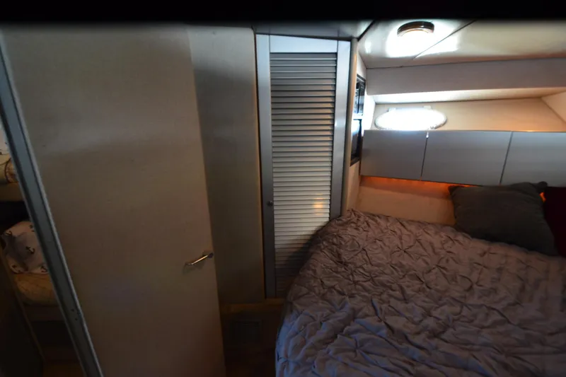 Slide: The Image of Cozy bedroom interior of 1991 Baron 43-E yacht with bed and storage. - 26