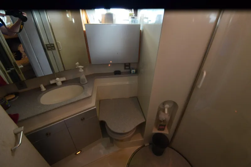 Slide: The Image of Compact bathroom in a 1991 Baron 43-E yacht with sink, toilet, and shower. - 29