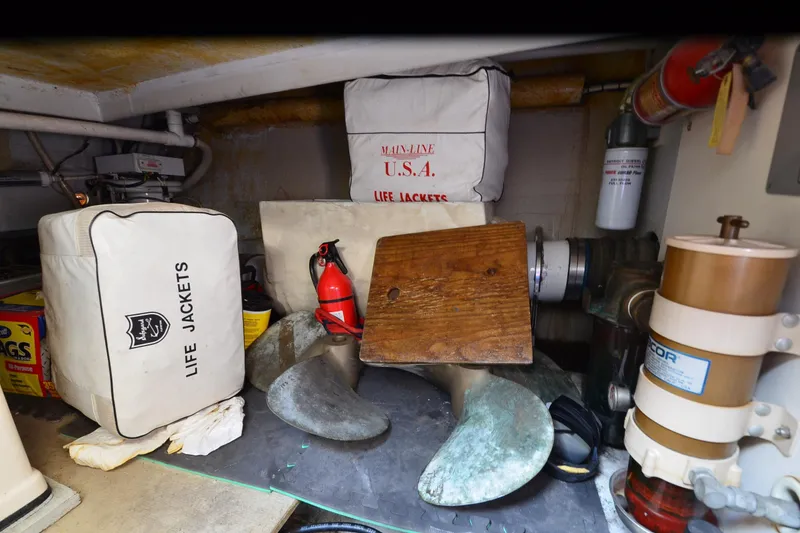 Slide: The Image of Storage area in a 1991 Baron 43-E boat with life jackets and safety equipment. - 38