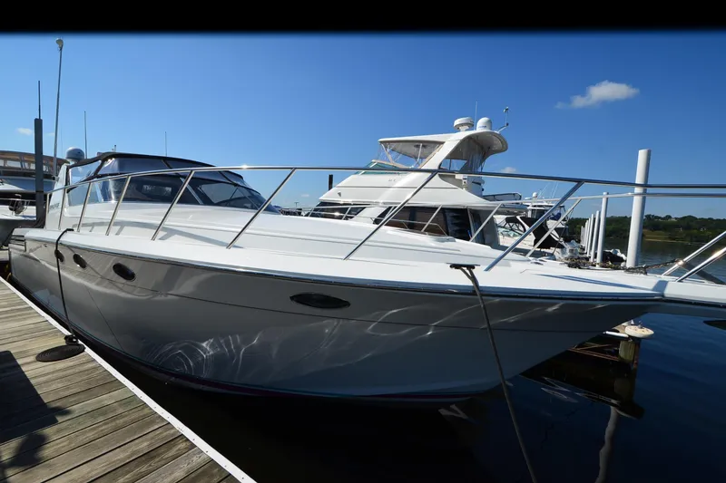 Slide: The Image of Luxury 1991 Baron 43-E yacht docked at marina under clear blue sky. - 5