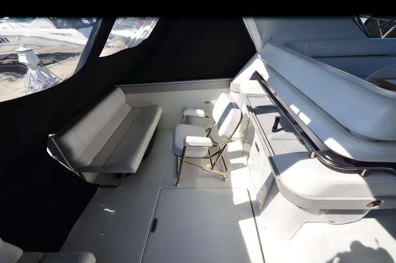 Slide: The Image of Interior of a 1991 Baron 43-E boat with white seating and modern design. - 8