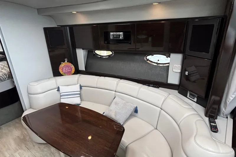 Slide: The Image of 2017 Formula 37 Performance Cruiser interior with white seating and table, overlooking water. - 26