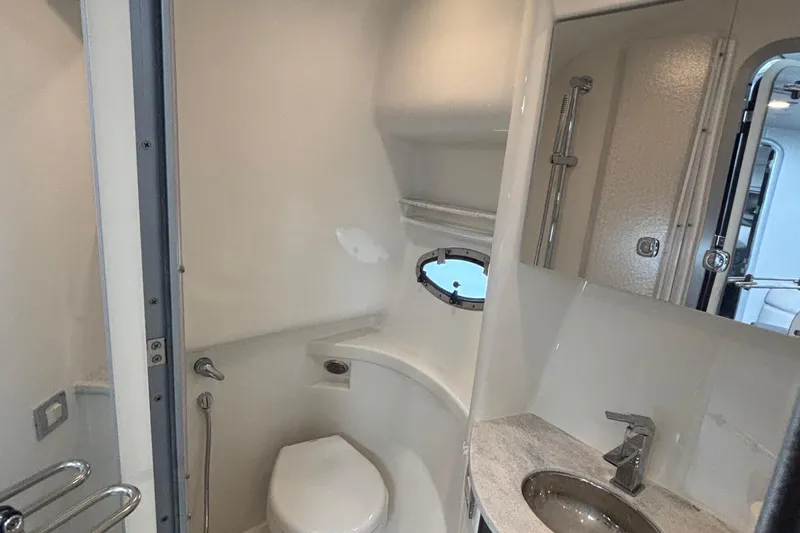 Slide: The Image of 2017 Formula 37 Performance Cruiser bathroom with modern fixtures and porthole window. - 51